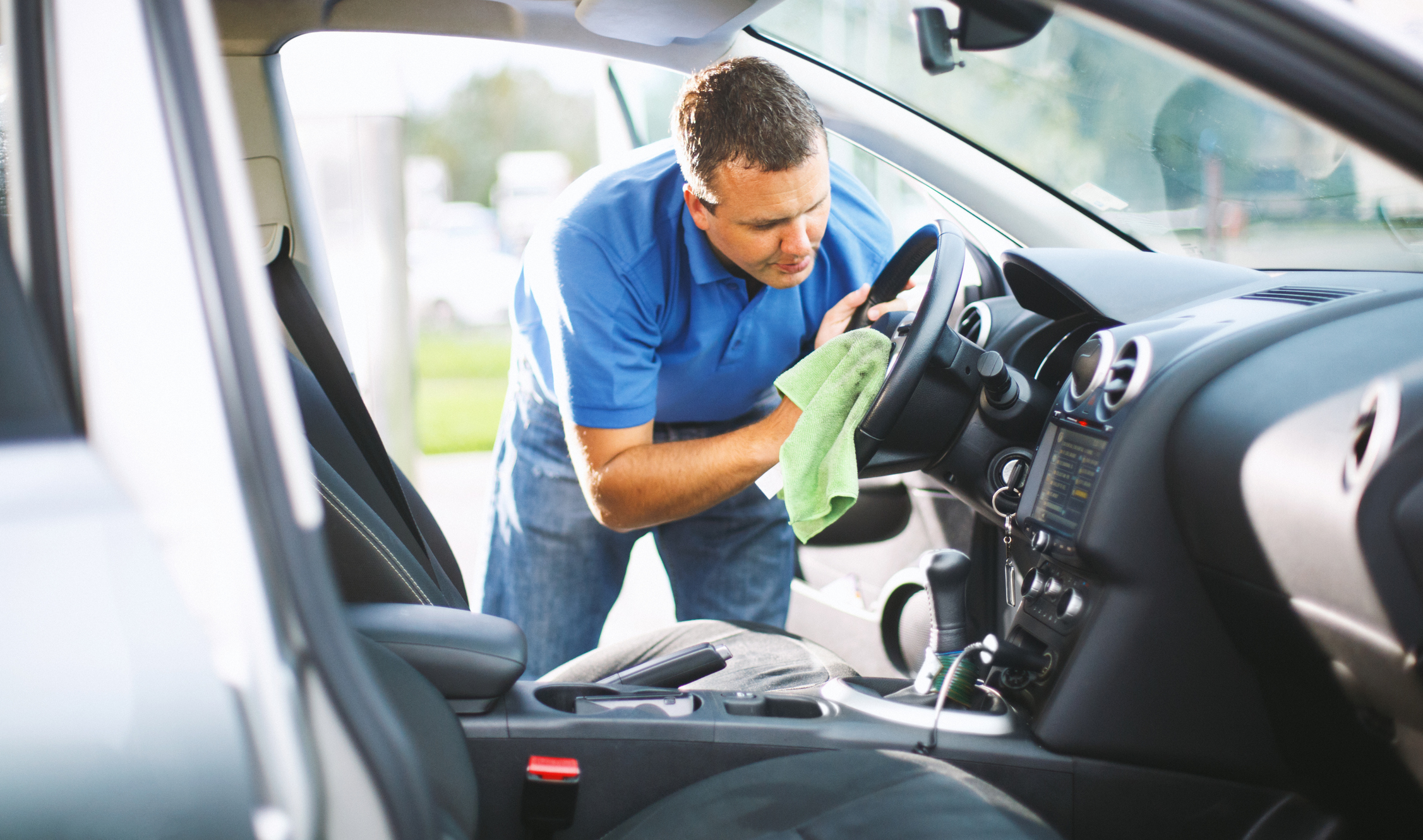 A man washing his car to keep it clean