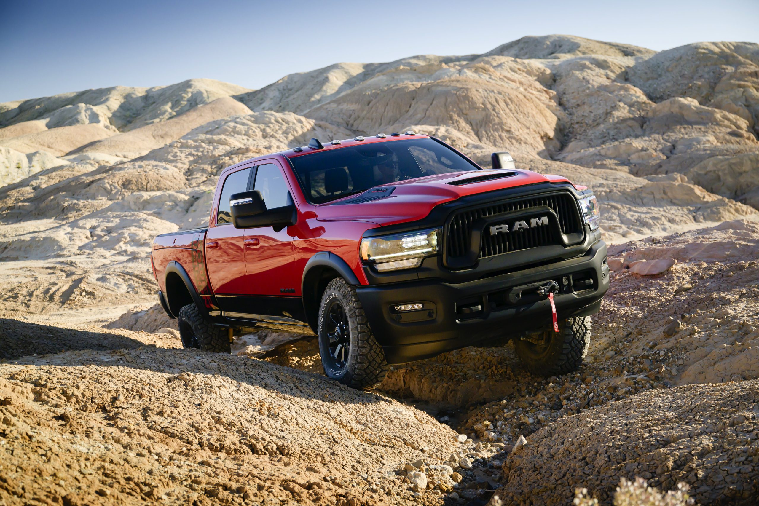 red 2024 RAM 3500 HD climbing rocky hills